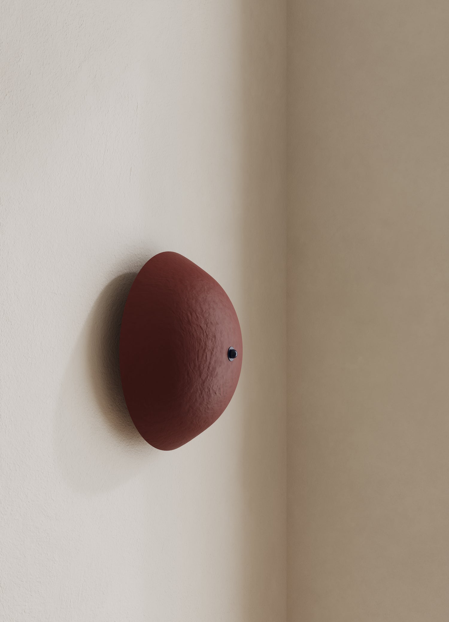 Wall-mounted domed light fixture with a burgundy shade and dark blue finial