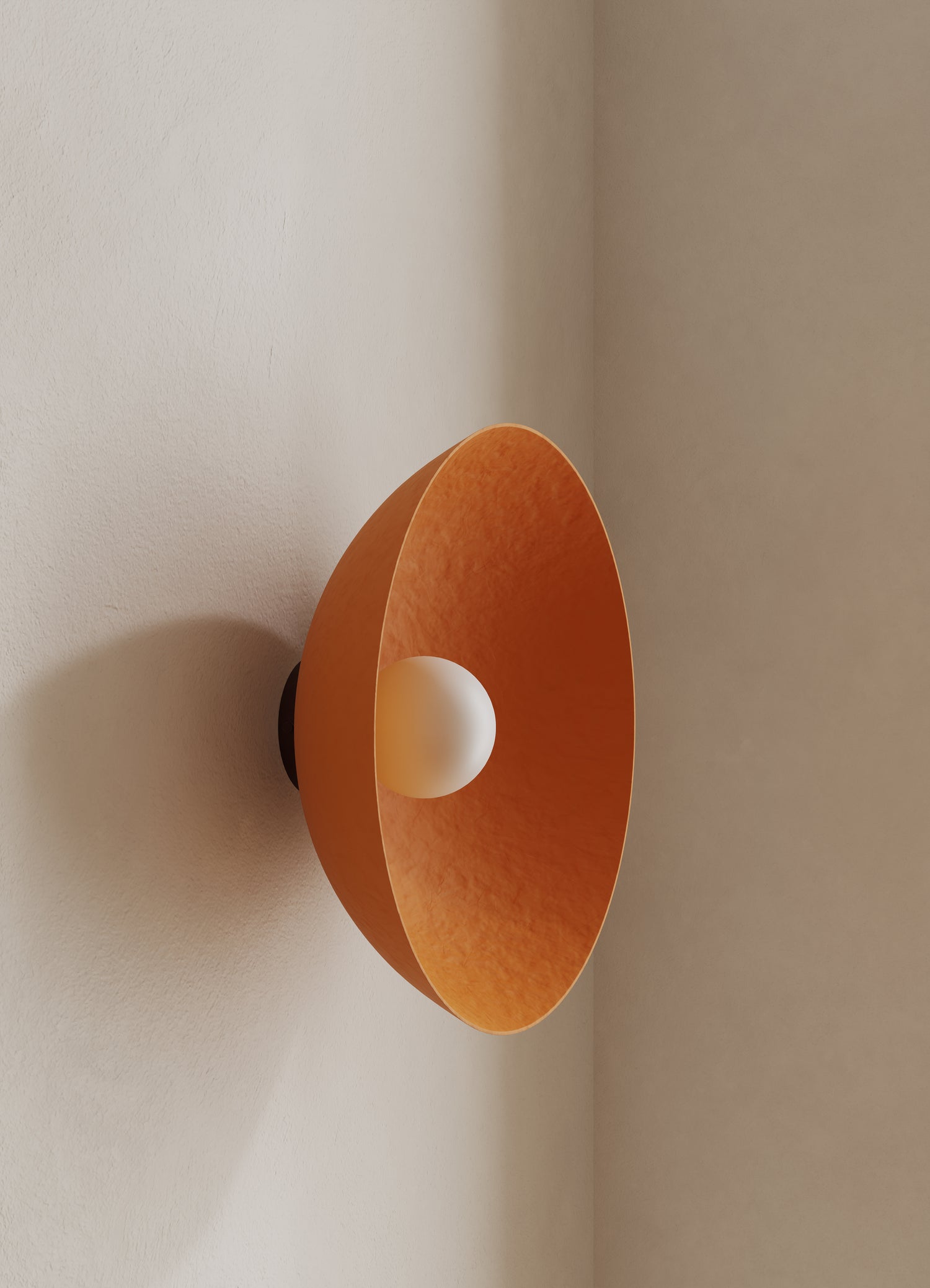 Wall light fixture with orange shade on a neutral wall