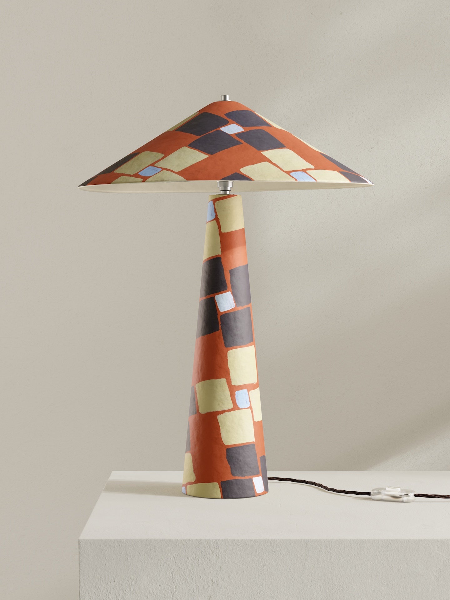 Parasol table lamp in Frieze pattern with mosaic design in orange, accented with brown, light blue, and pale yellow details