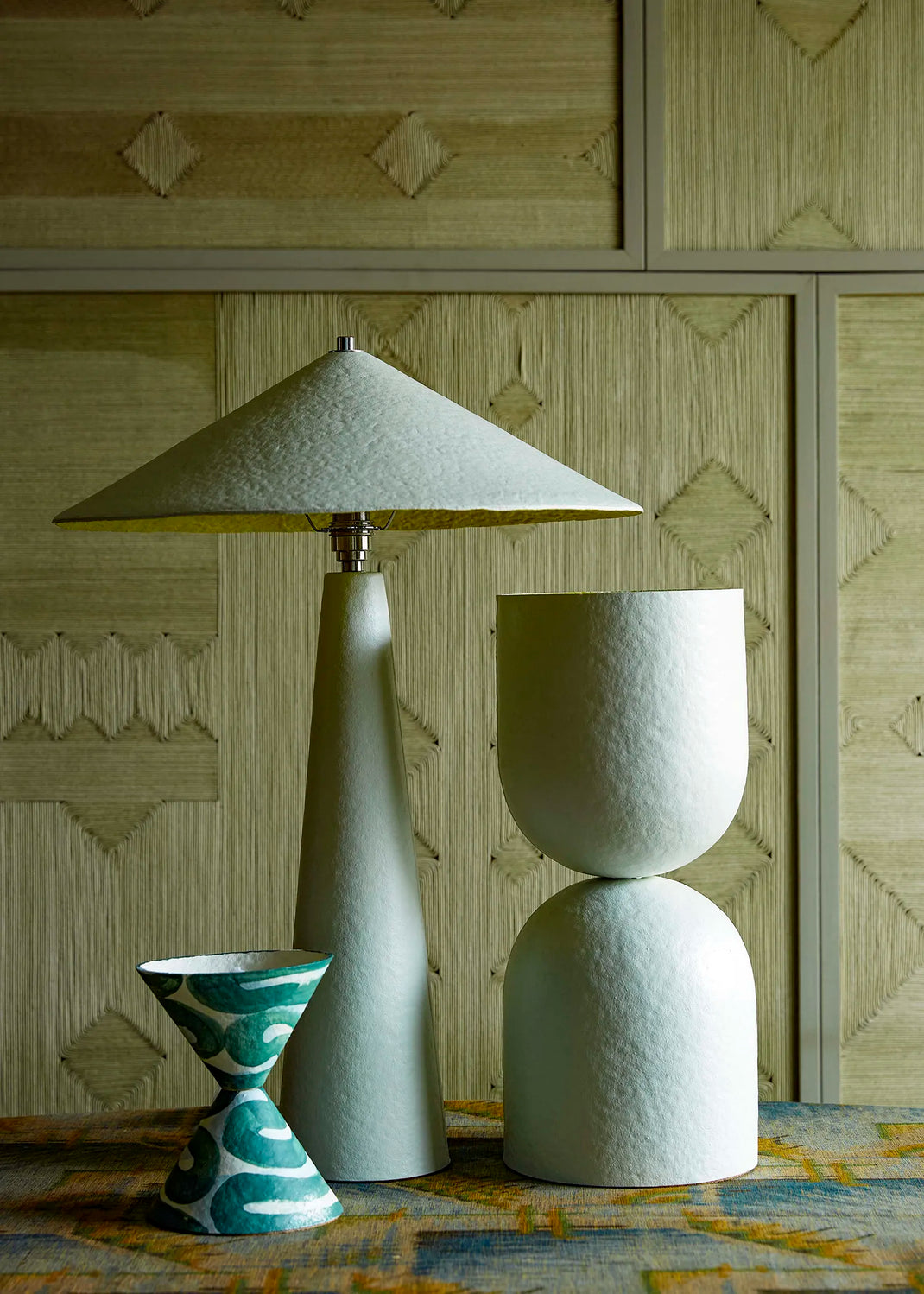Set of table lamps against a textured wall.