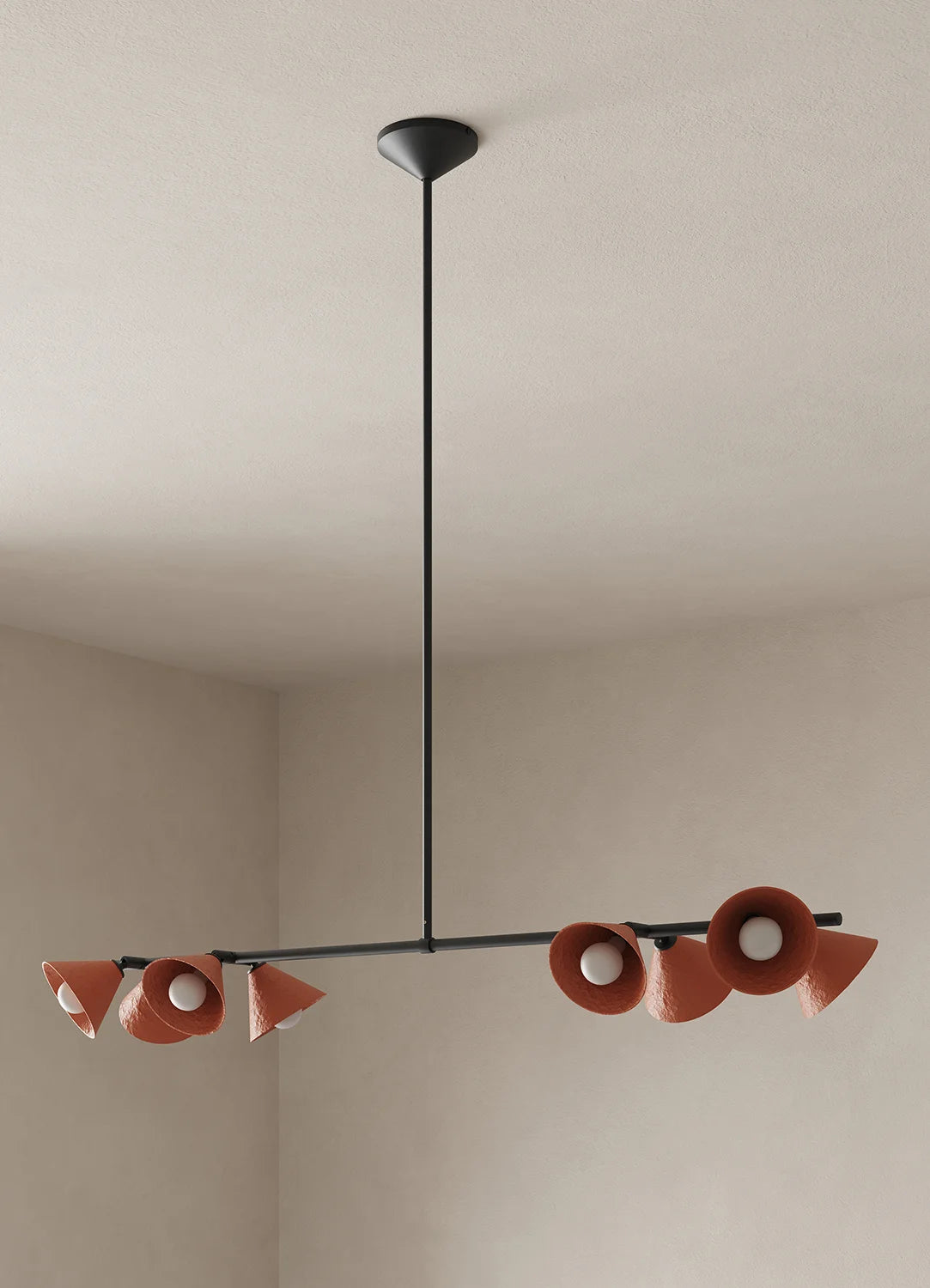 A modern multi-light linear chandelier with terracotta-colored cone-shaped shades and a black metal frame, suspended from a ceiling in a minimalist room.