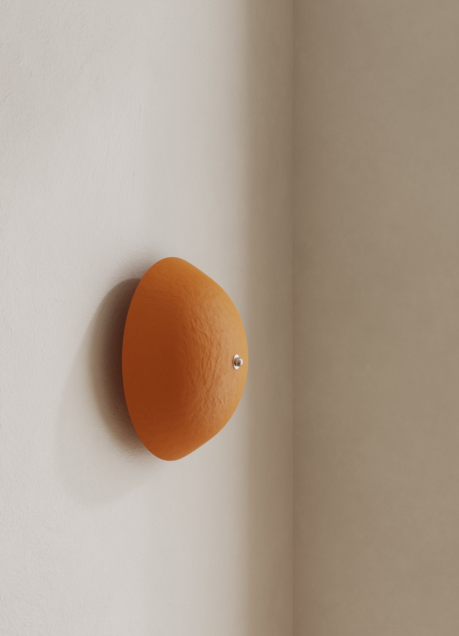 Wall-mounted domed light fixture with an orange shade