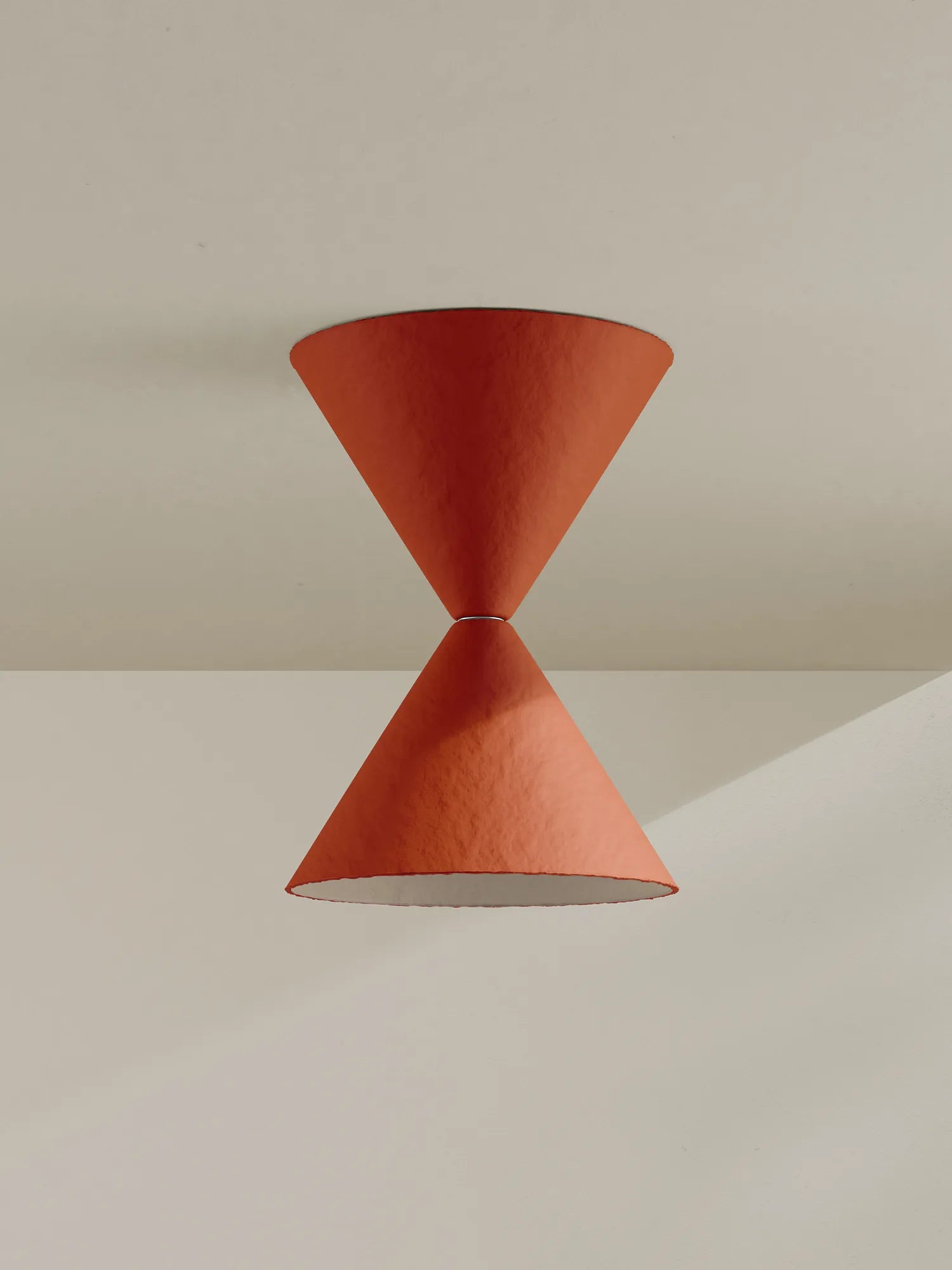 Red pendant light fixture on a neutral background