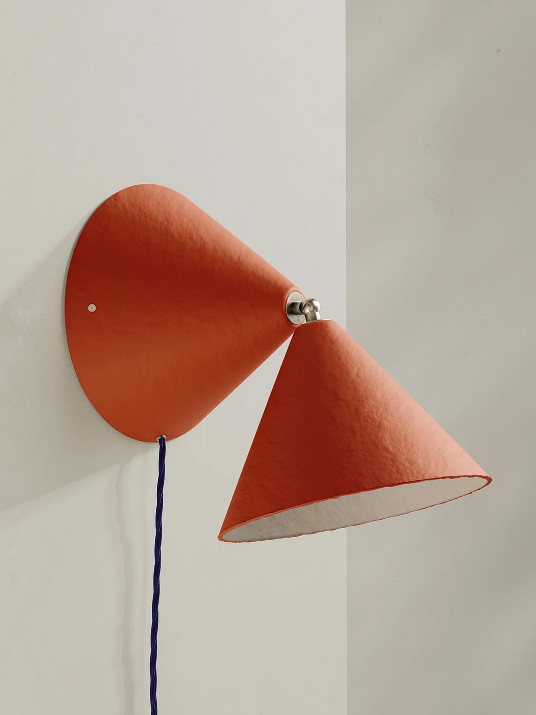 Red wall-mounted lamp with a white interior on a light gray background