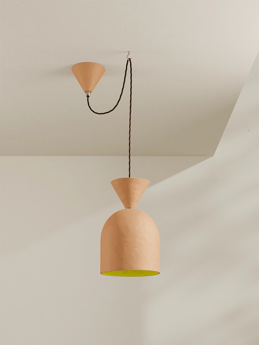 Pendant light with a yellow interior on a neutral background
