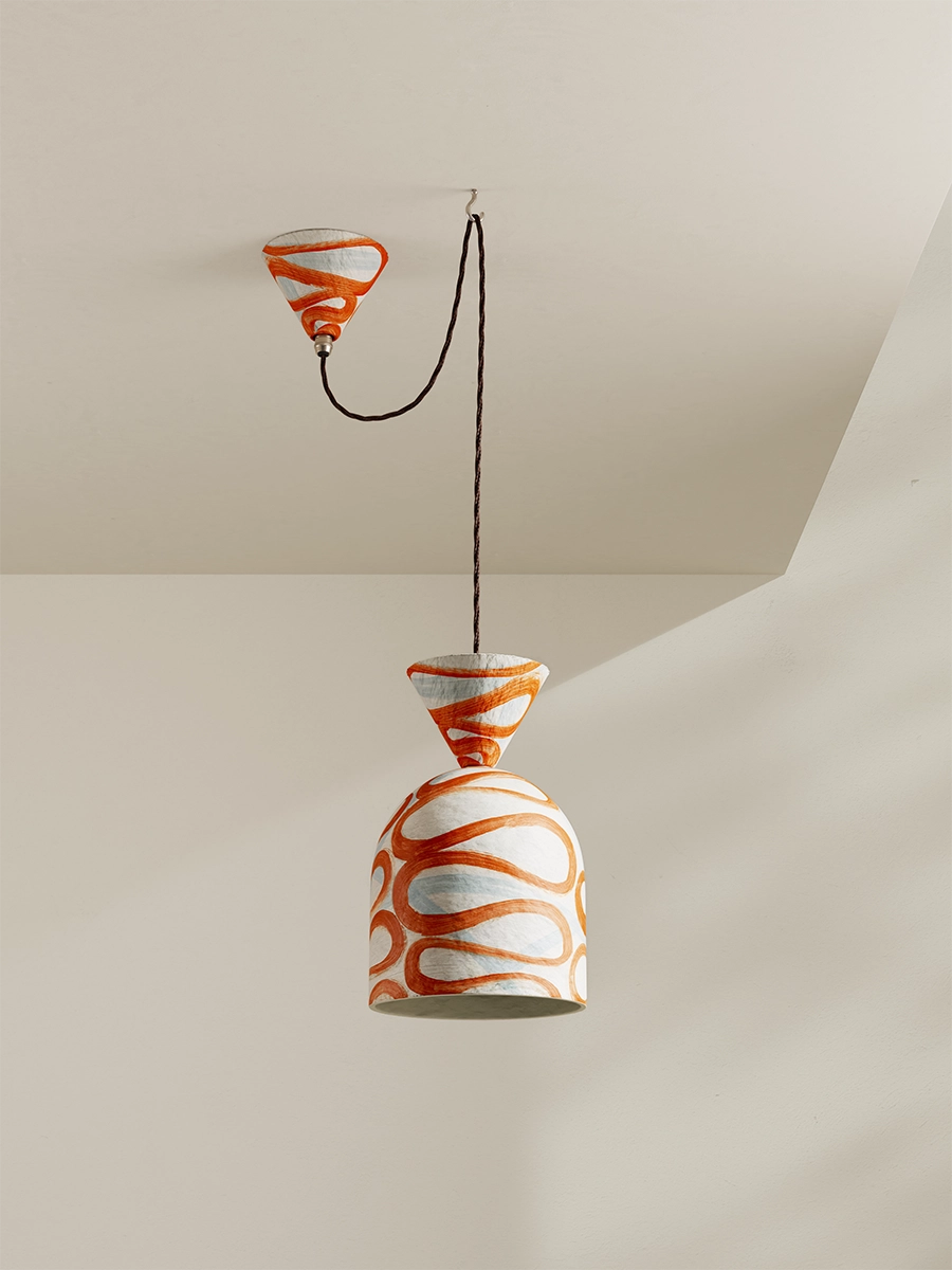 Pendant light with orange and white design on a neutral background