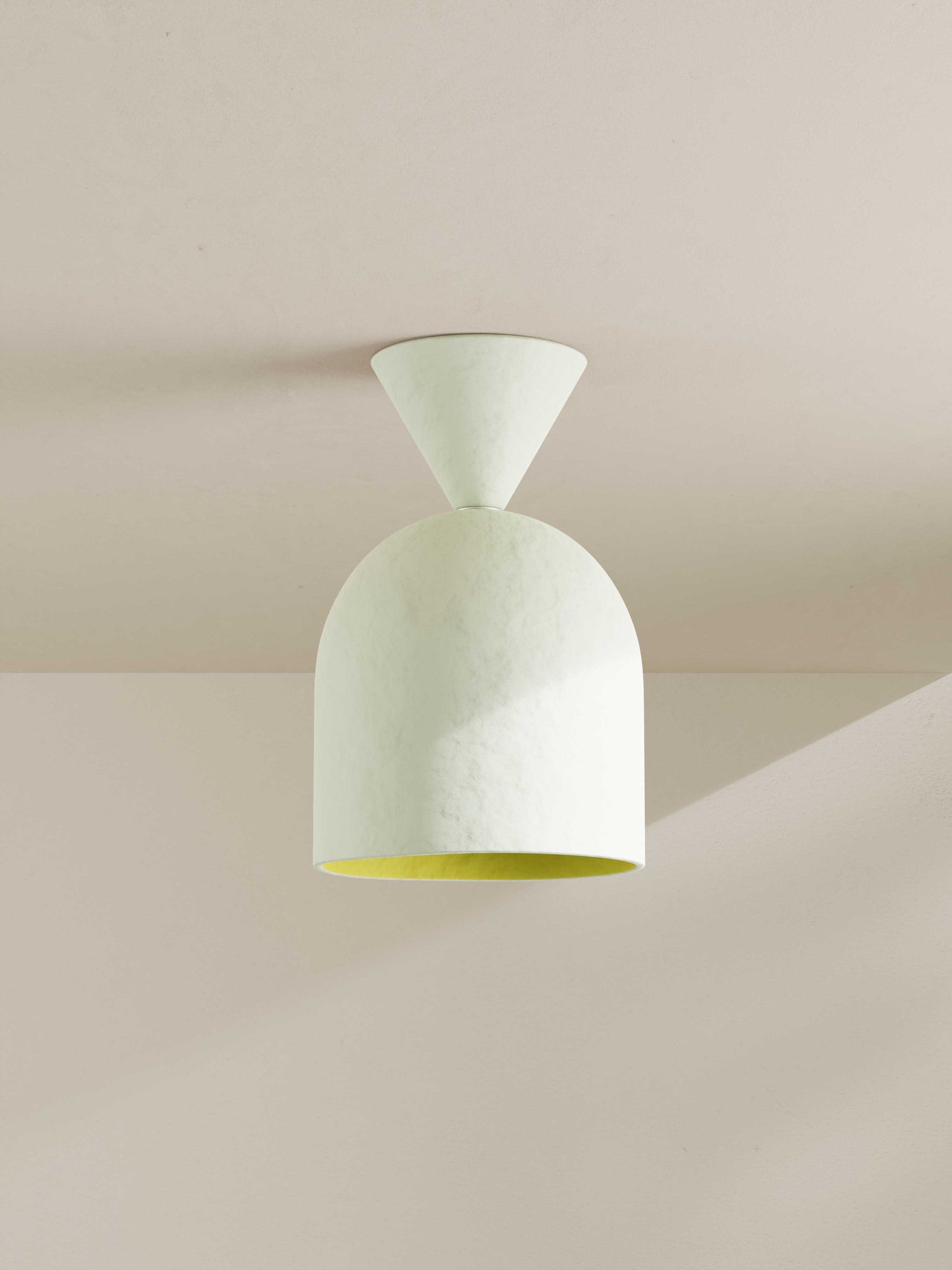 Bell Surface Mount ceiling light made of paper pulp and hand-painted in off-white with a bright yellow shade interior