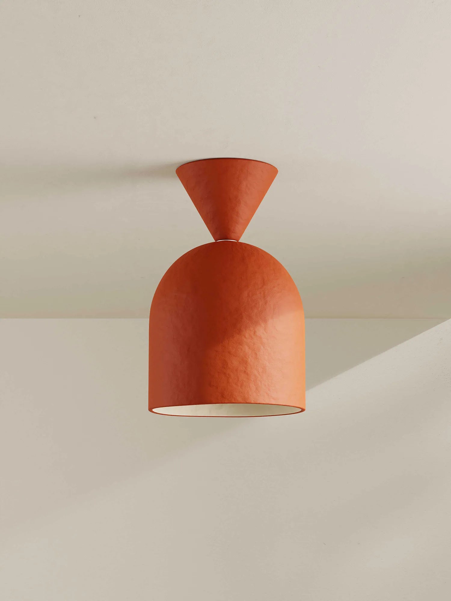 Brick-orange ceiling light fixture on a neutral background