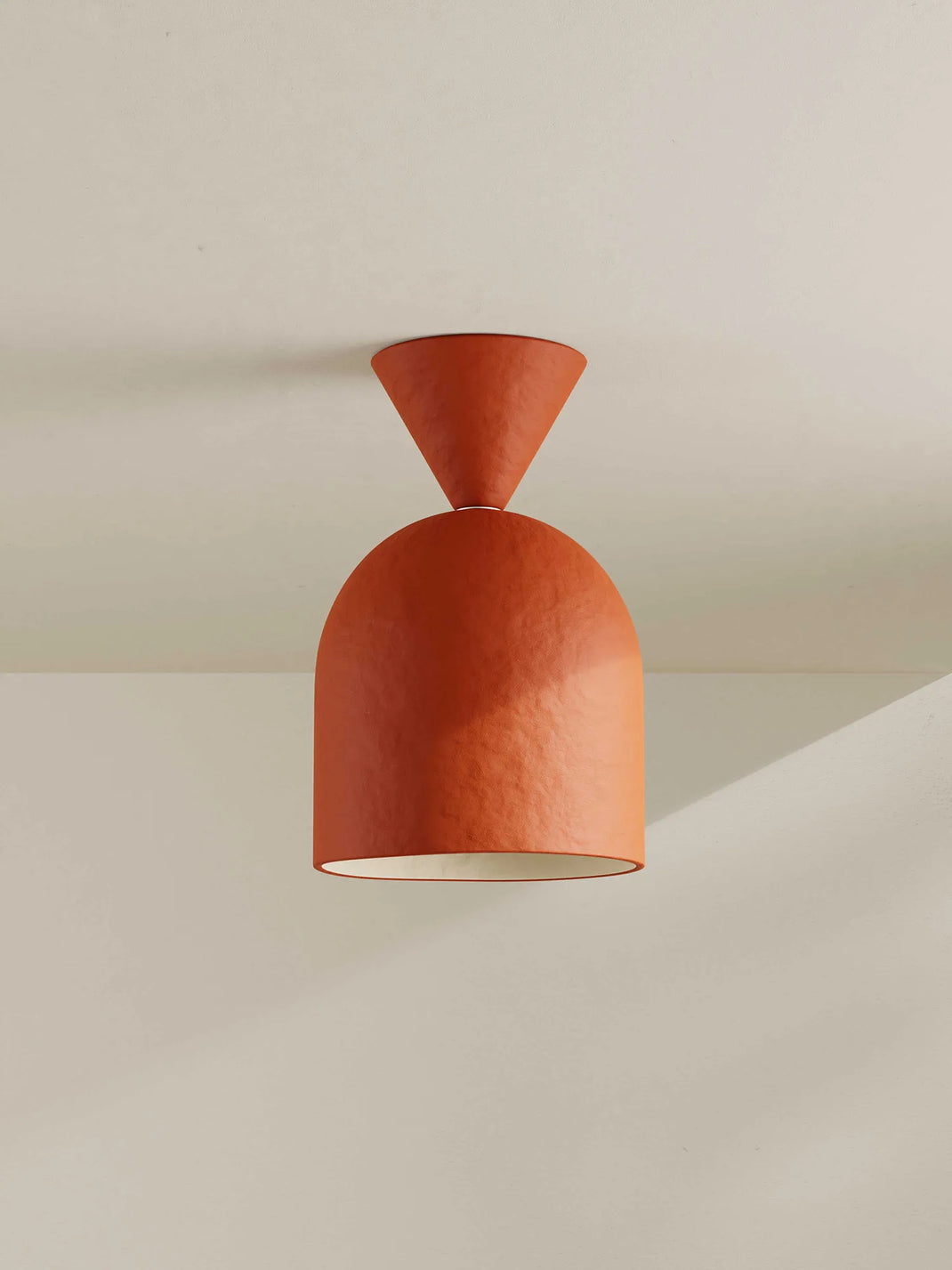 Brick-orange ceiling light fixture on a neutral background