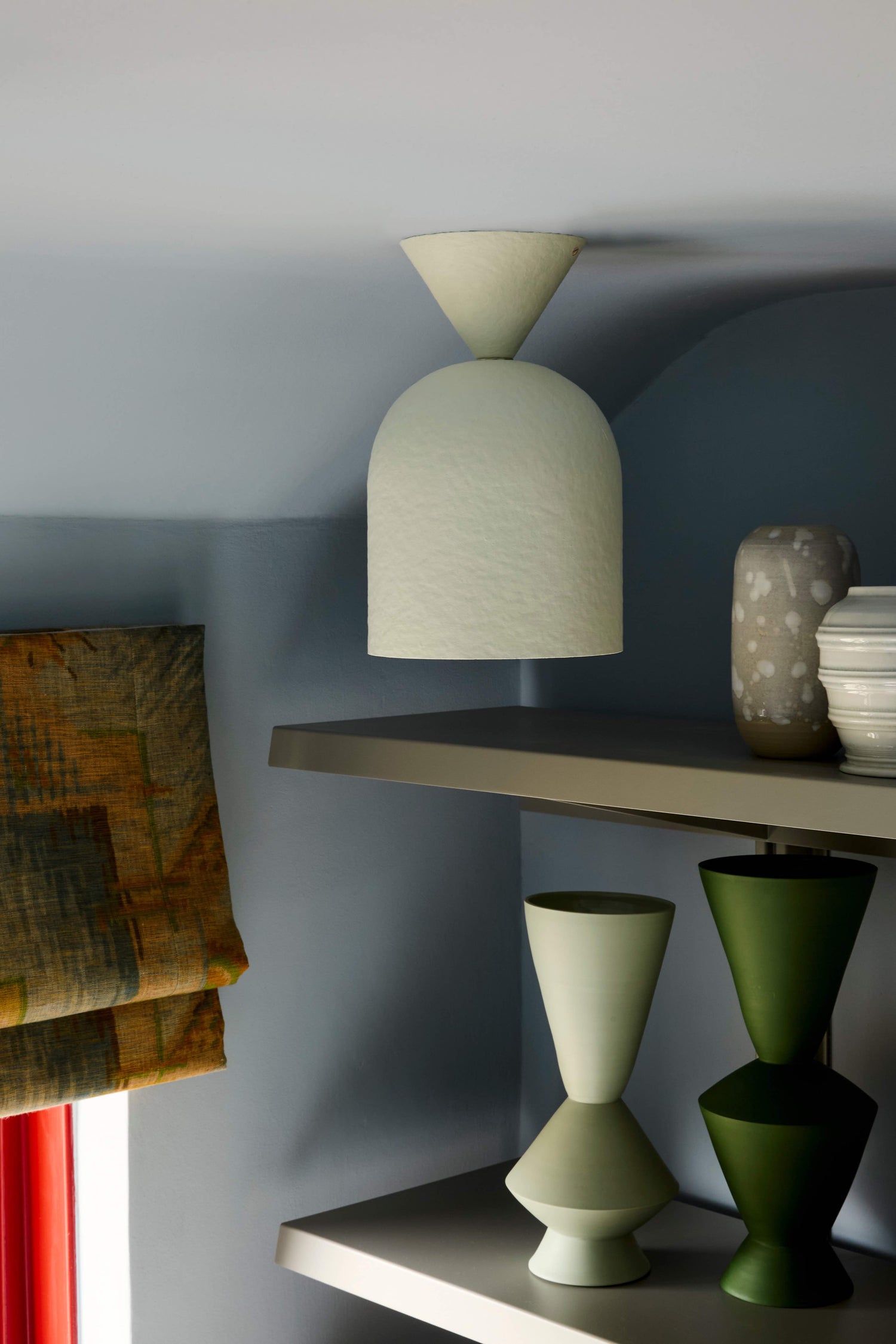 Bell Surface Mount ceiling light, made of paper pulp and hand-painted in off-white affixed to a bedroom ceiling.
