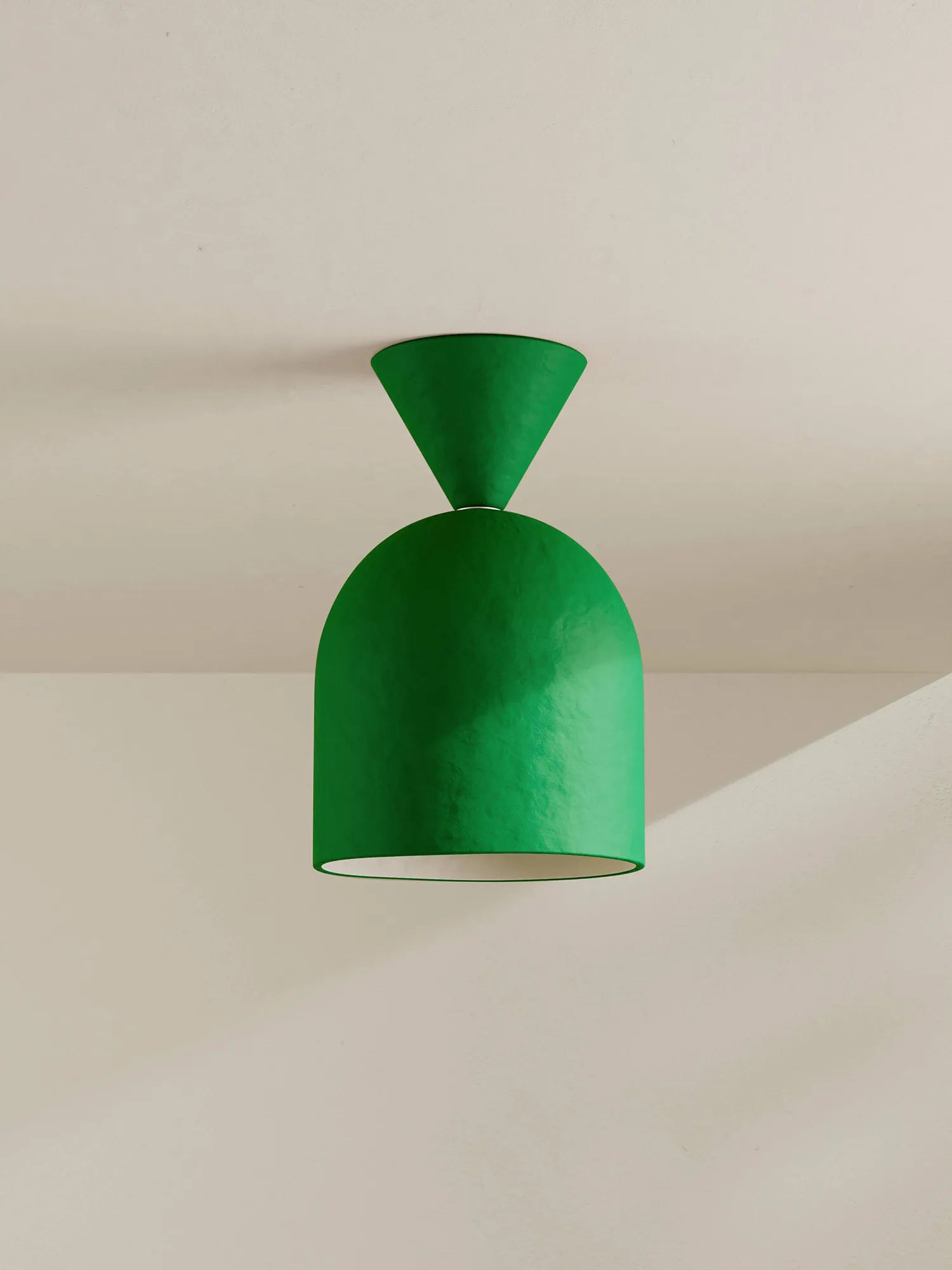 Green ceiling light fixture on a neutral background