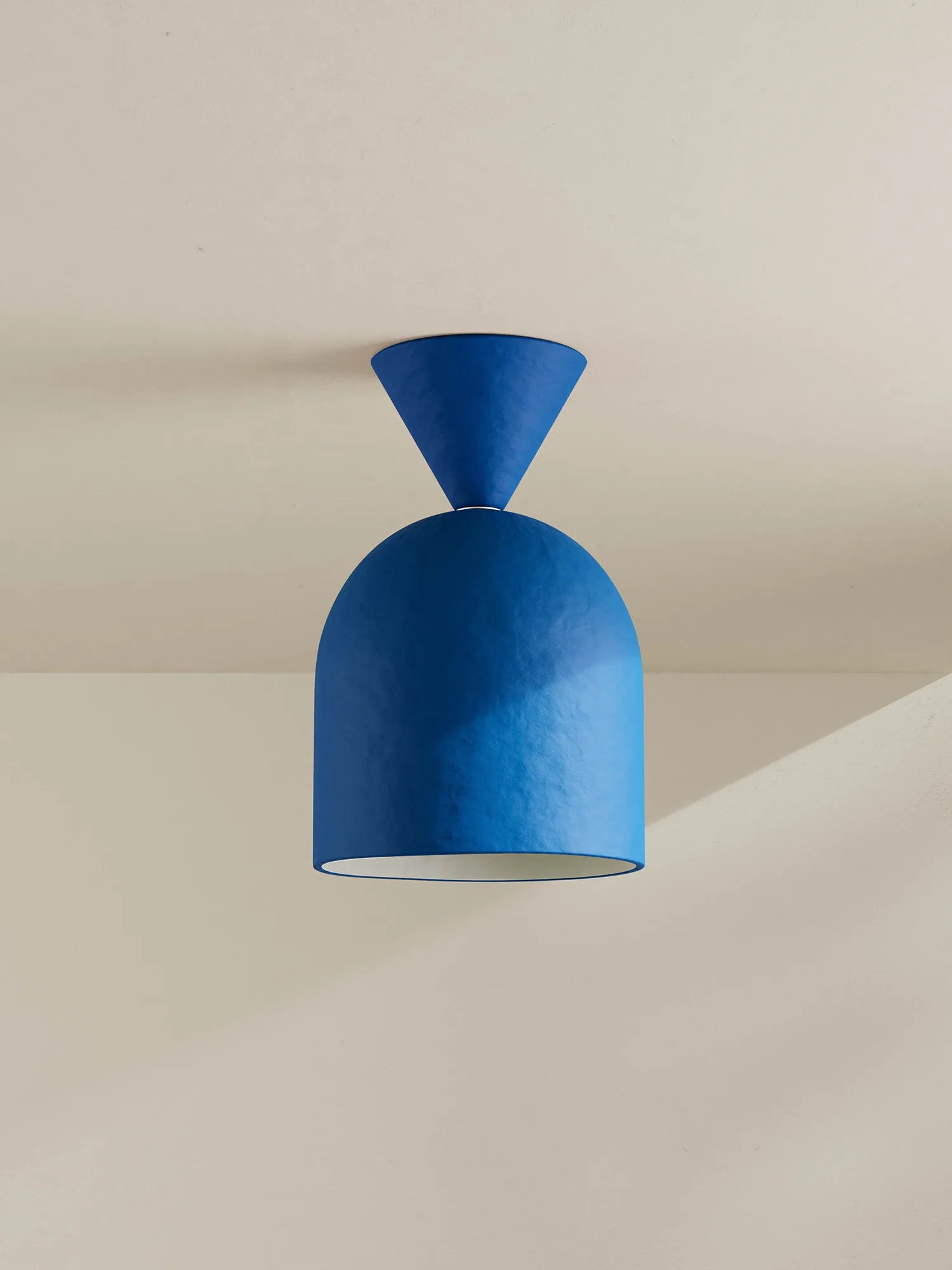 Blue ceiling light fixture on a neutral background