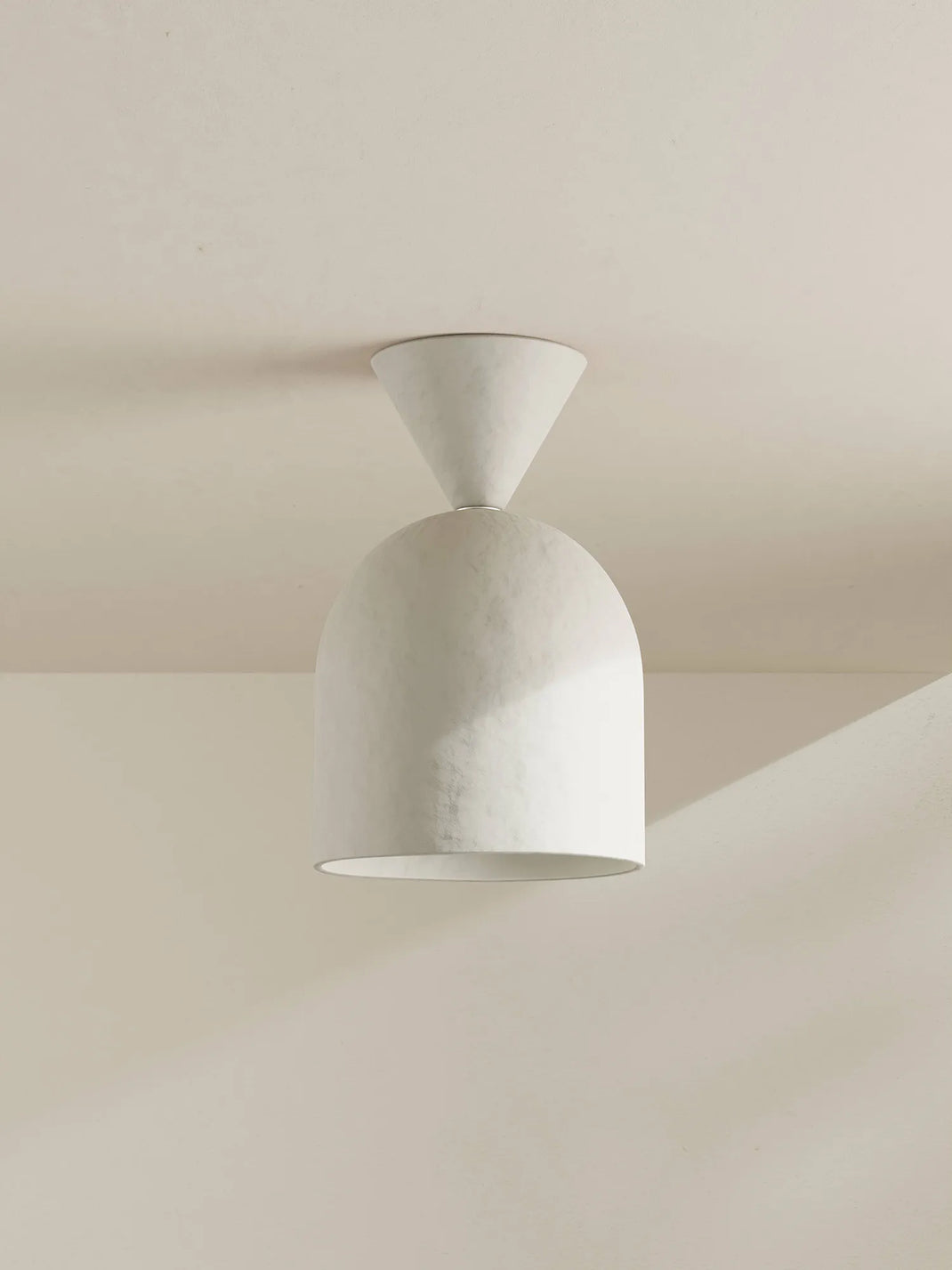 White ceiling light fixture on a neutral background