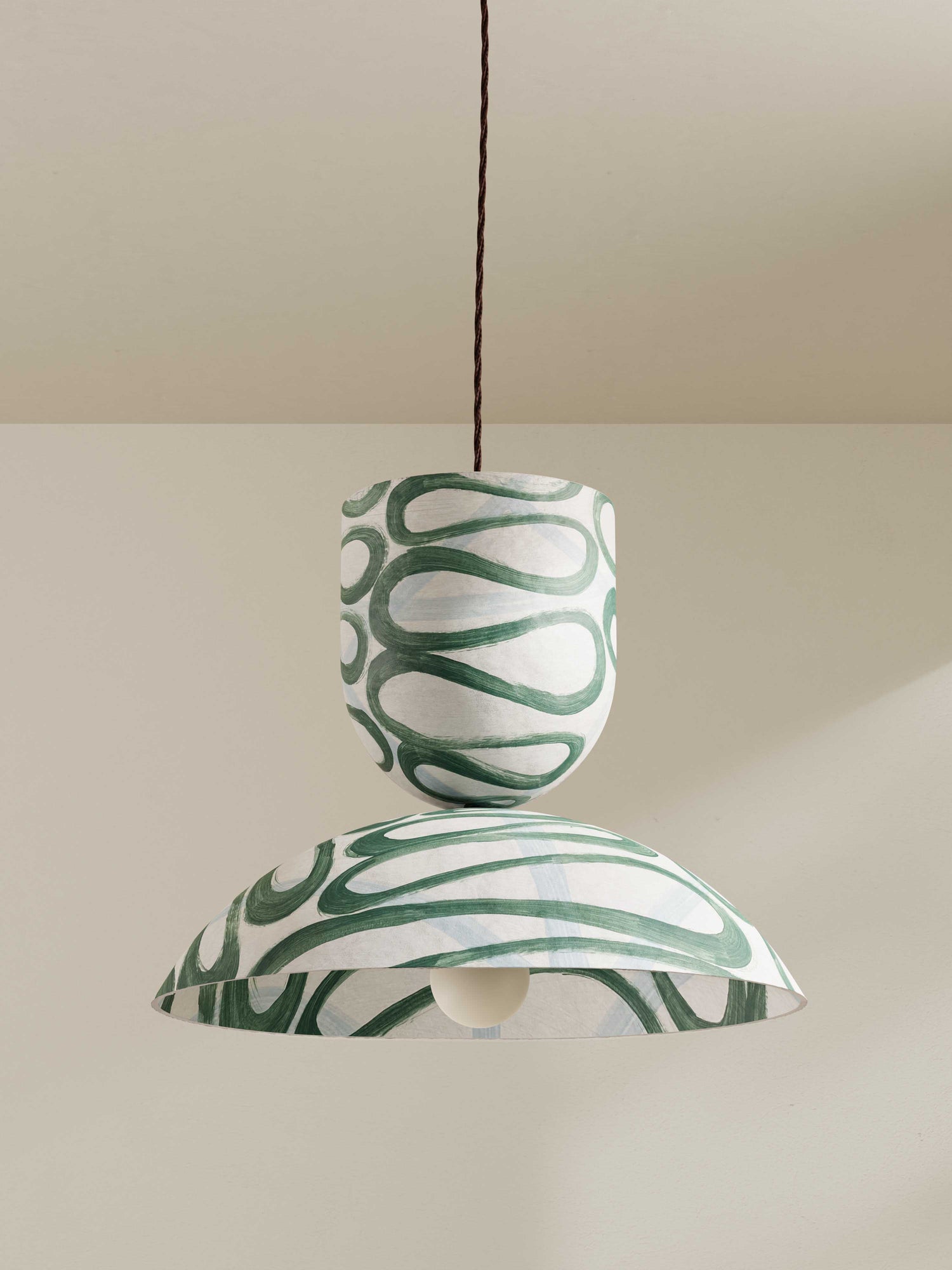 Buoy pendant, a large ceiling light made of paper pulp and hand-painted in green swirling Serpent pattern.