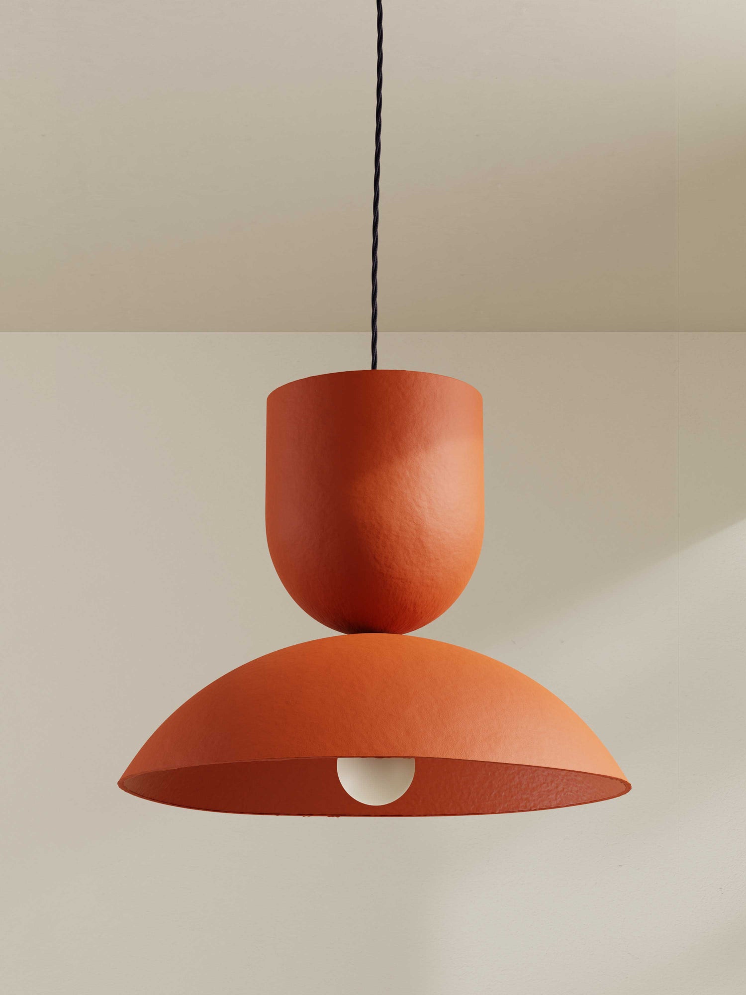 Buoy pendant, a large ceiling light made of paper pulp and hand-painted in orange/red hue