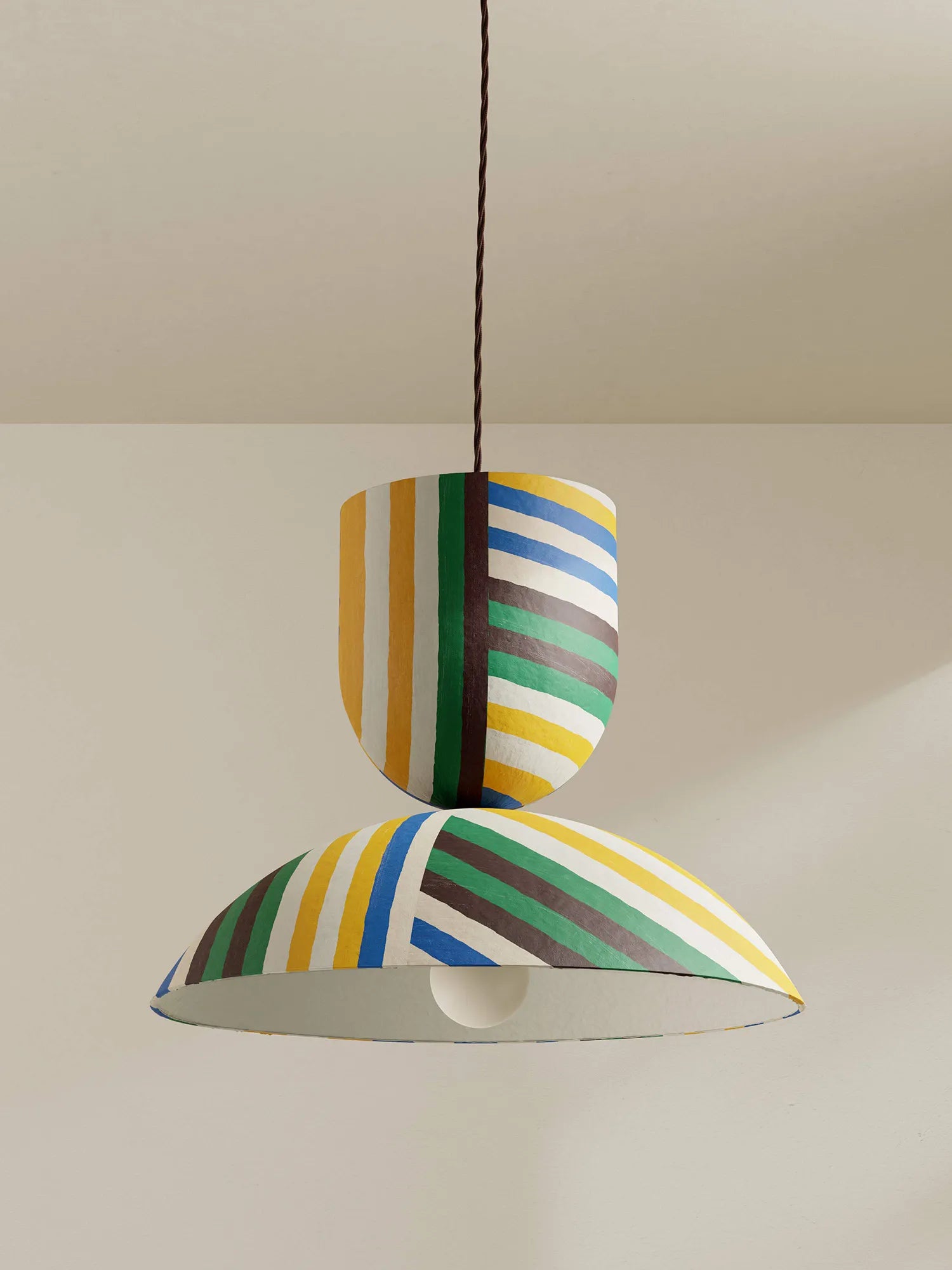 Colorful striped pendant light against a neutral background