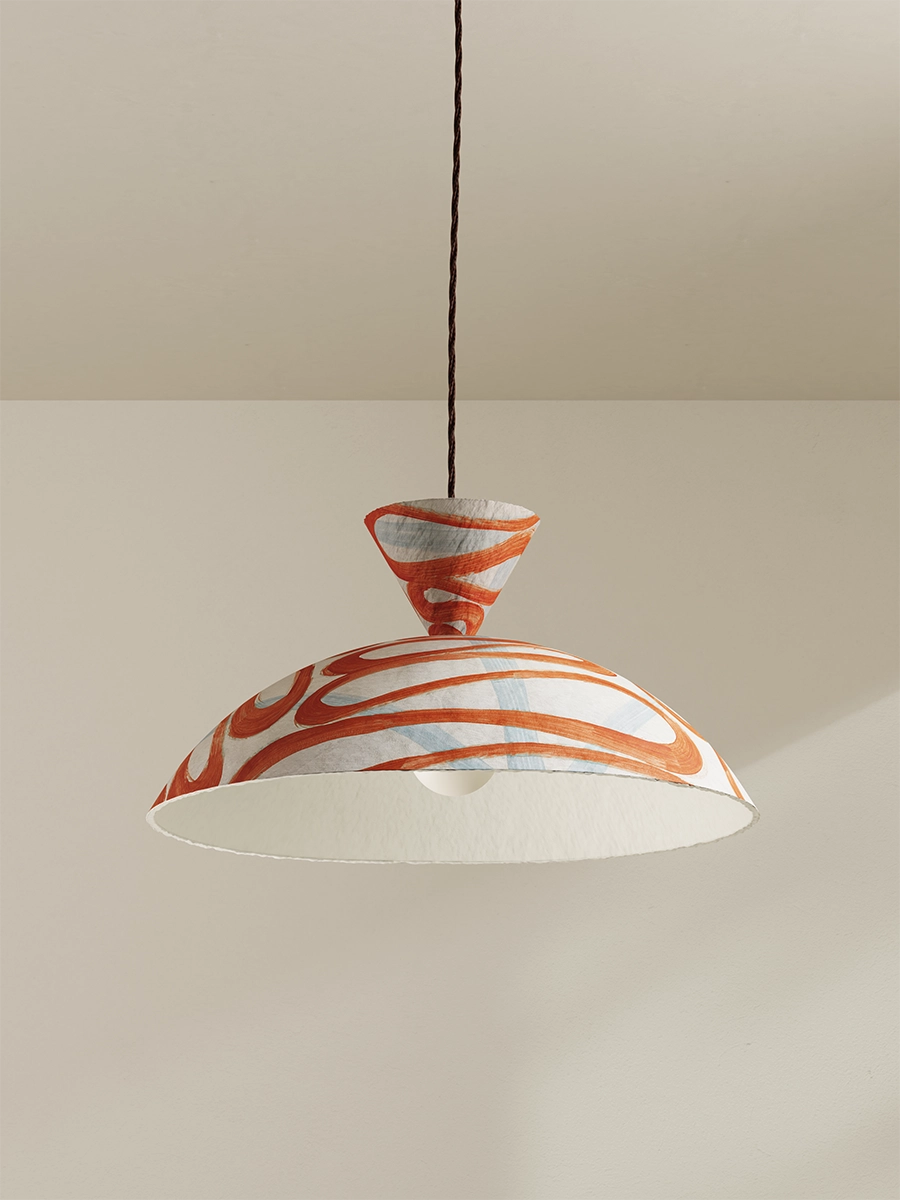 Pendant light with orange and white design on a plain background