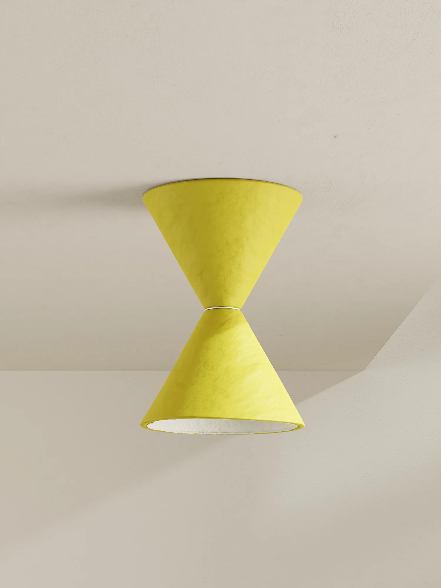 A modern two-cone pendant light fixture in yellow against a warm off-white ceiling.