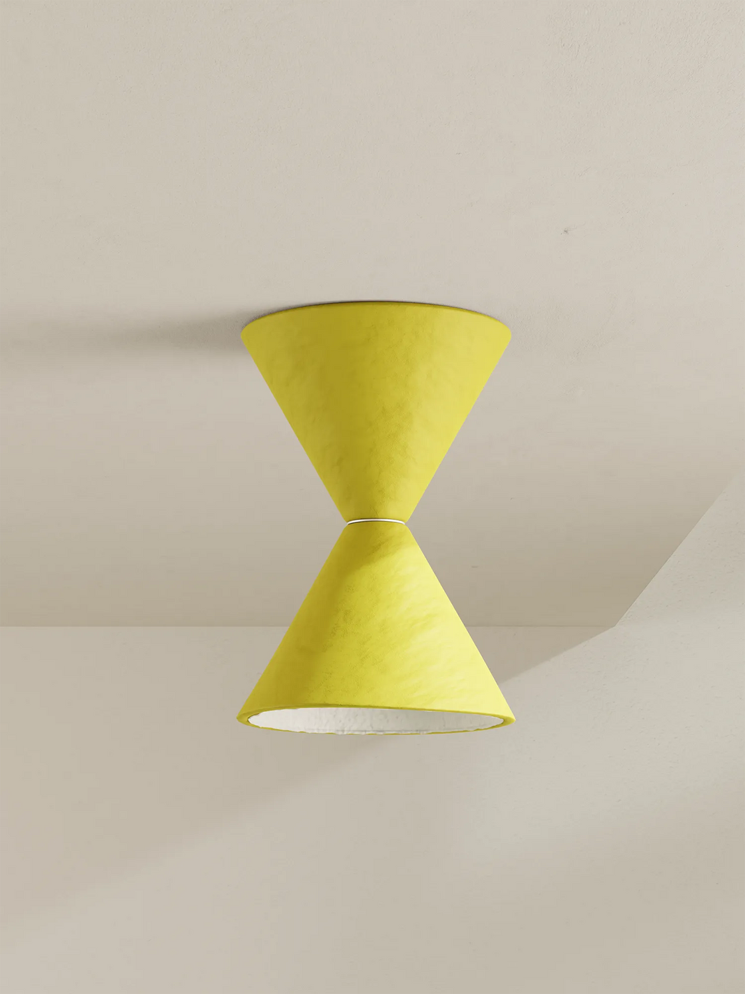 A modern two-cone pendant light fixture in yellow against a warm off-white ceiling.
