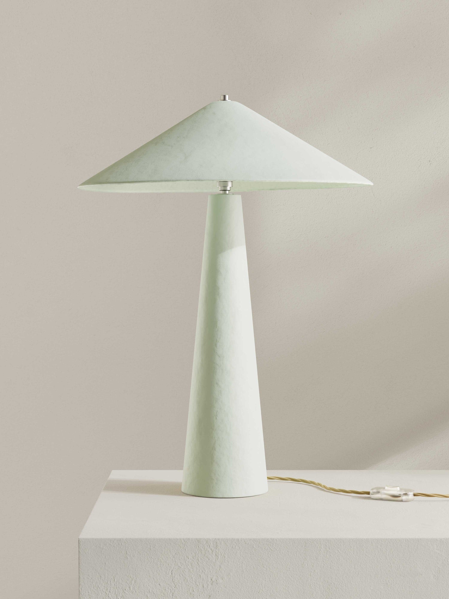 Parasol table lamp with tall stem and wide shade, made of hand-painted paper pulp in off-white