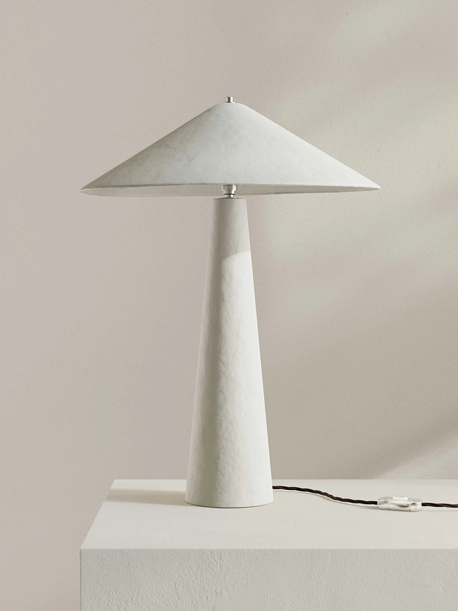 White table lamp with a cone-shaped shade on a neutral background