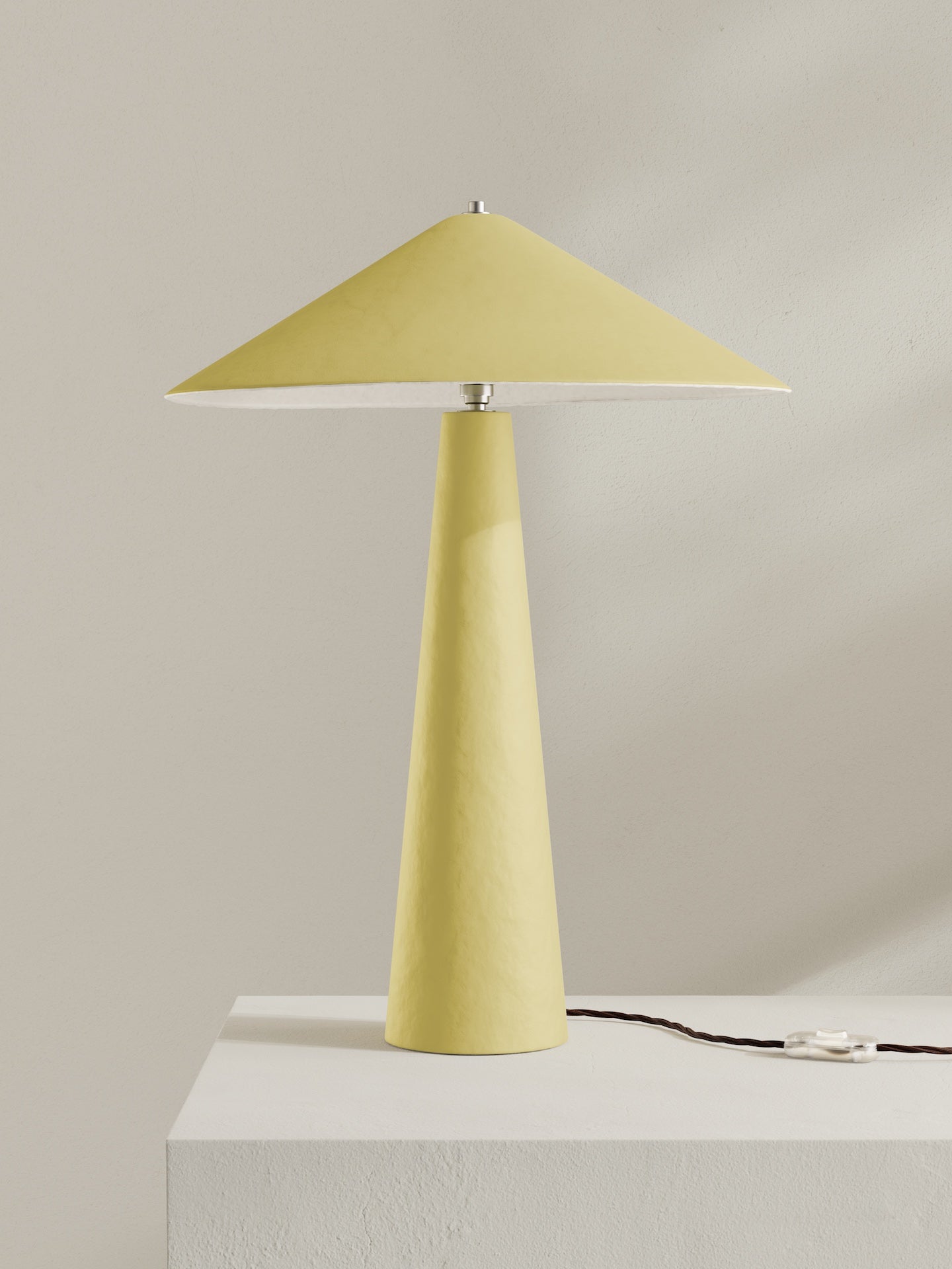 Parasol table lamp with tall stem and wide shade, made of hand-painted paper pulp in sherbet yellow