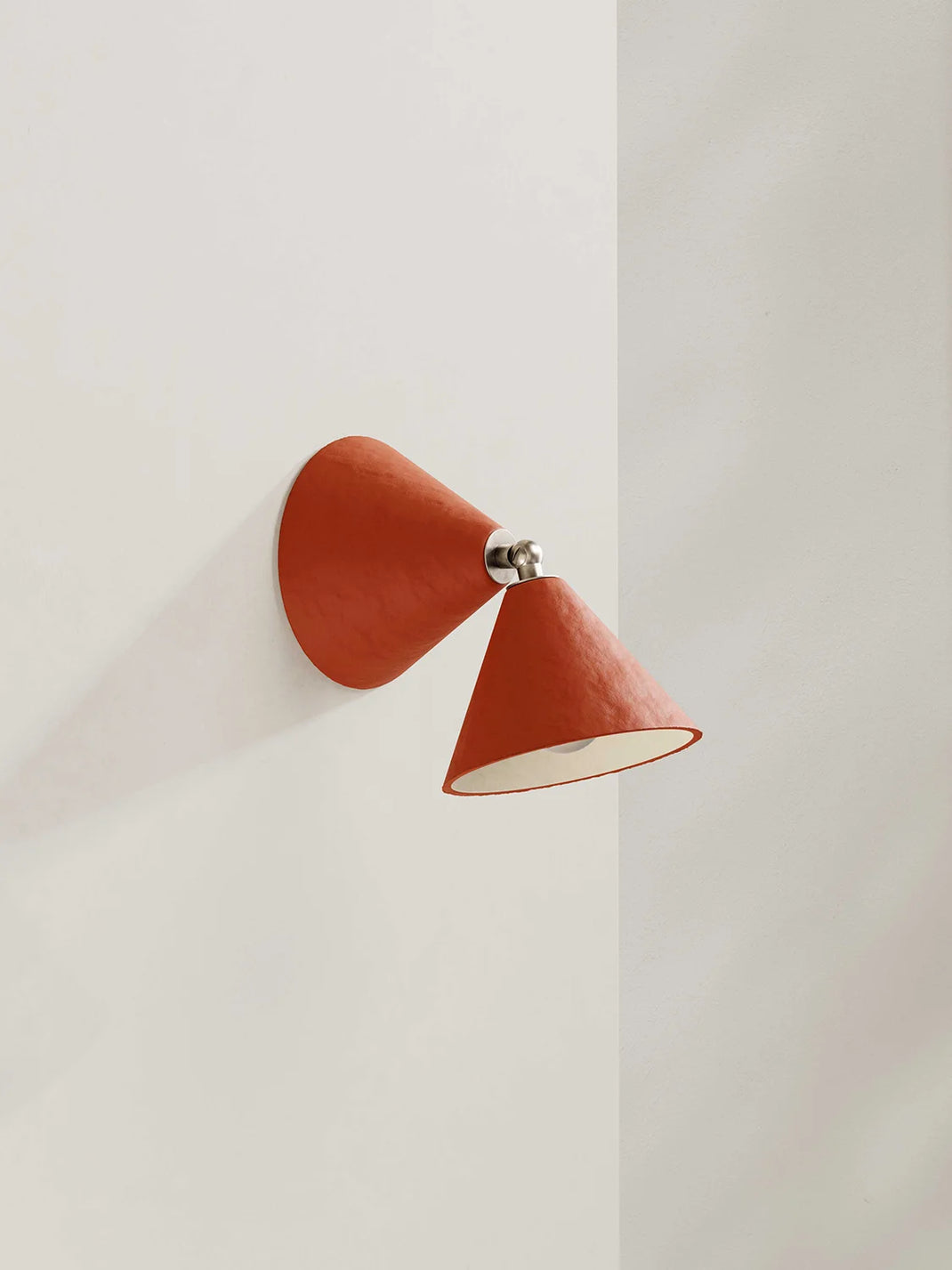 Red wall lamp on a white wall