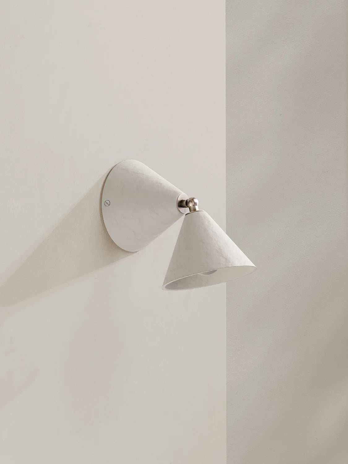 Modern wall-mounted light fixture on a plain wall