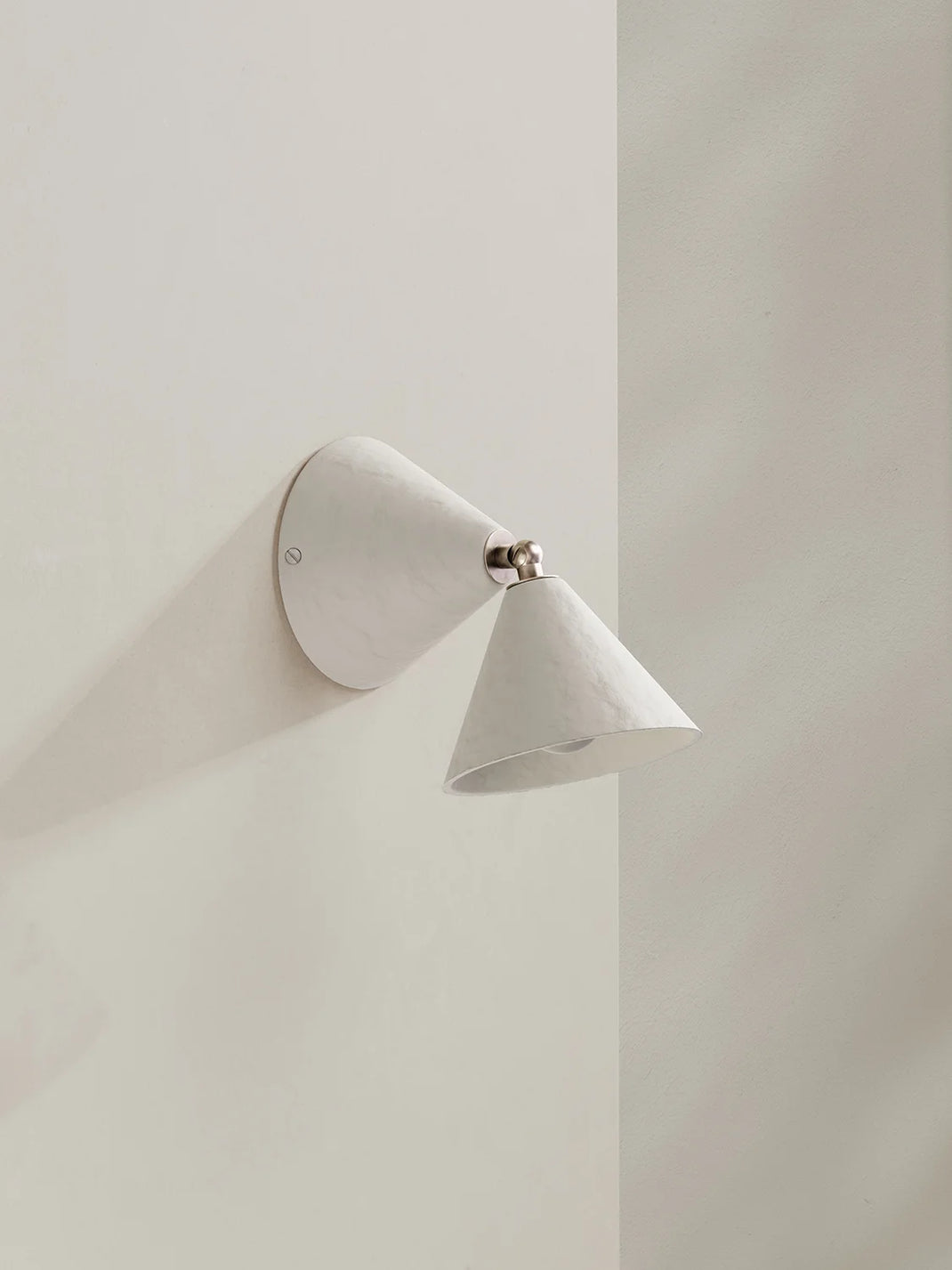 Modern wall-mounted light fixture on a plain wall