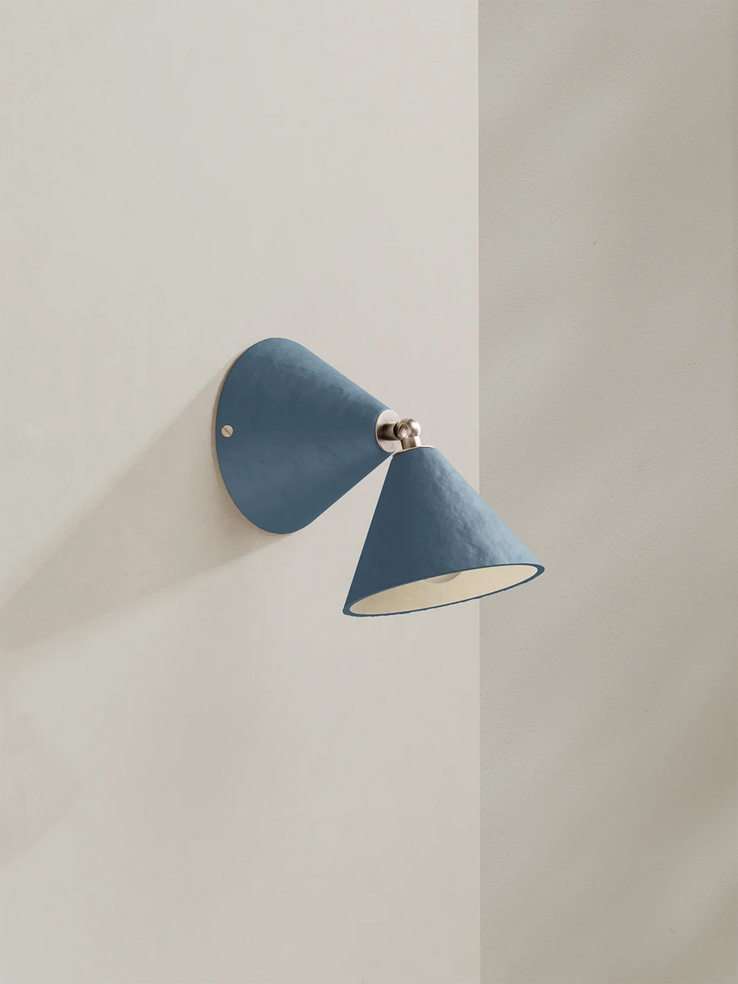Blue wall sconce on a light beige wall