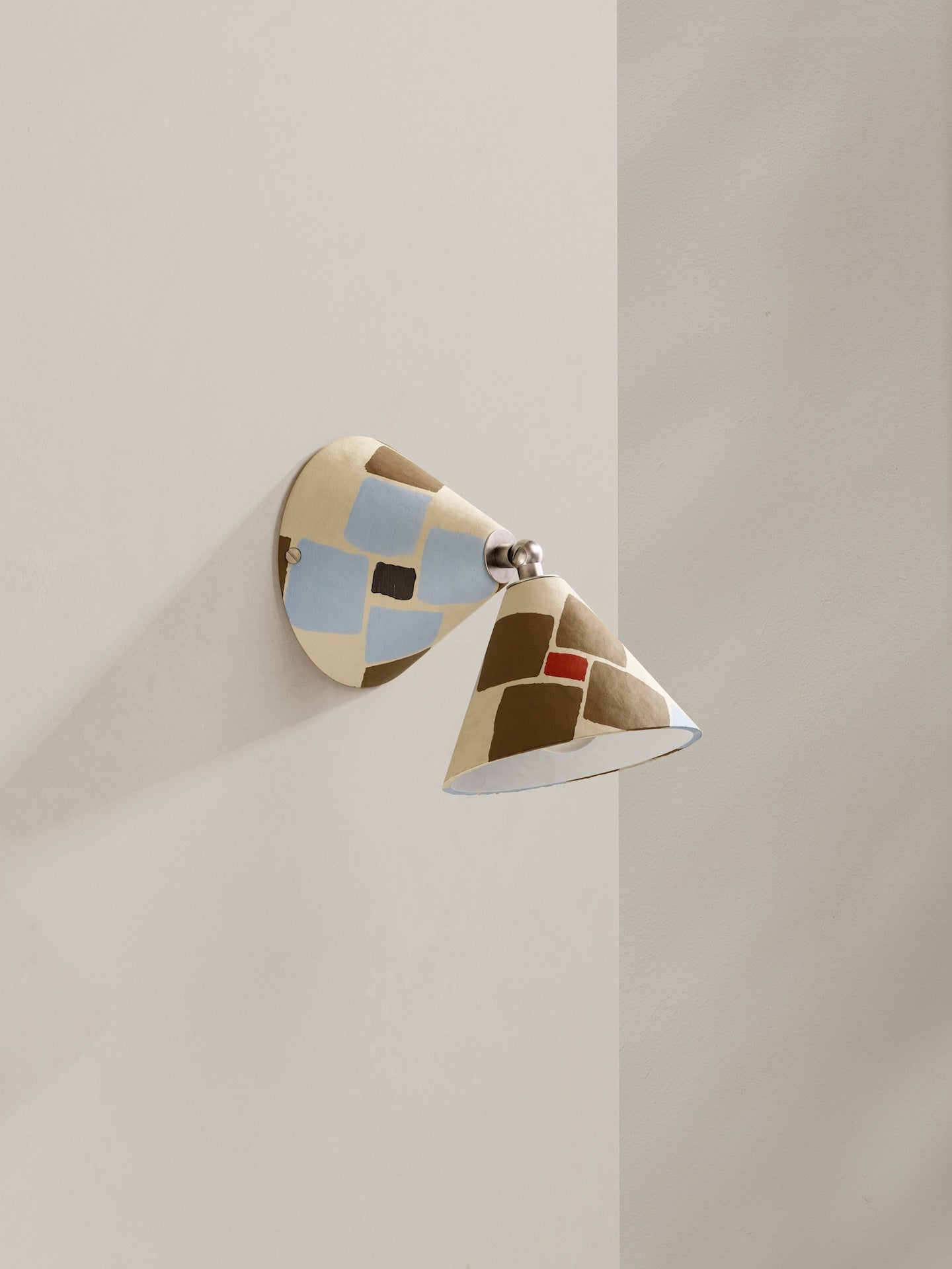 Hardwired Rotor wall light - a conical shape wall light, in hand-painted paper pulp, mosaic pattern with cream base colour and light blue, dark gold and orange accents.