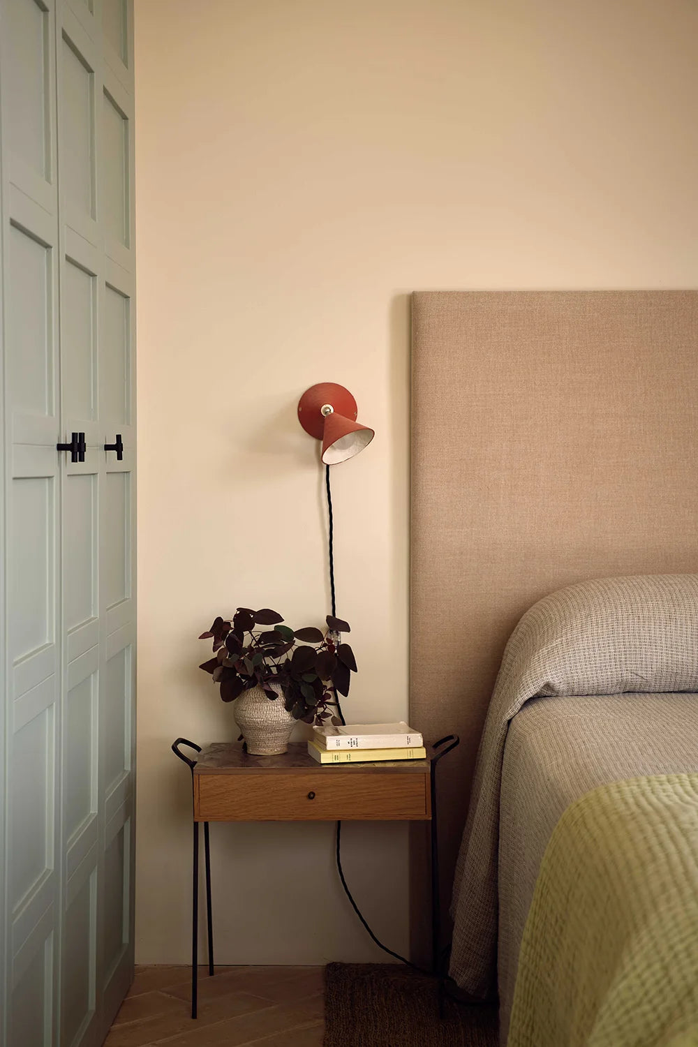 Bedroom with a nightstand, lamp, and bed.