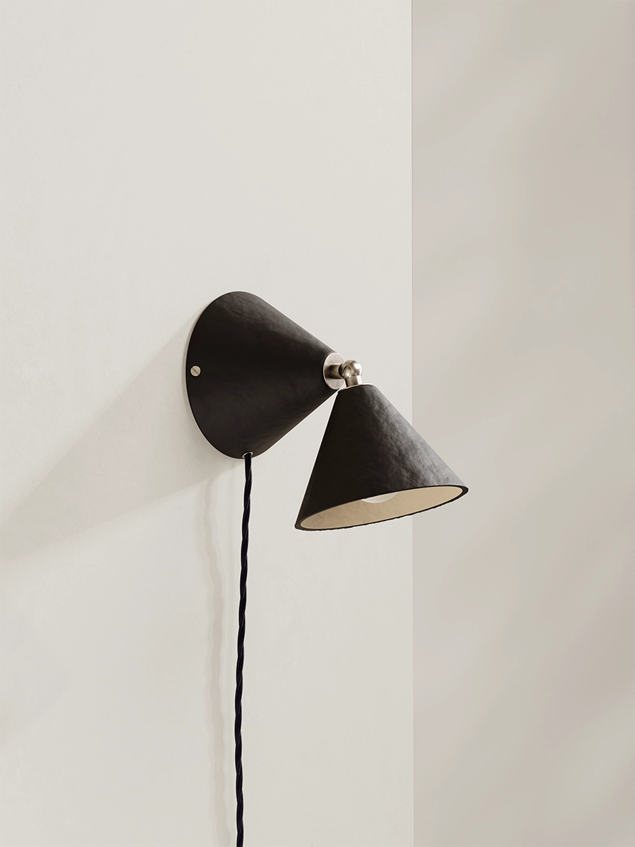 Brown-black wall lamp against neutral background