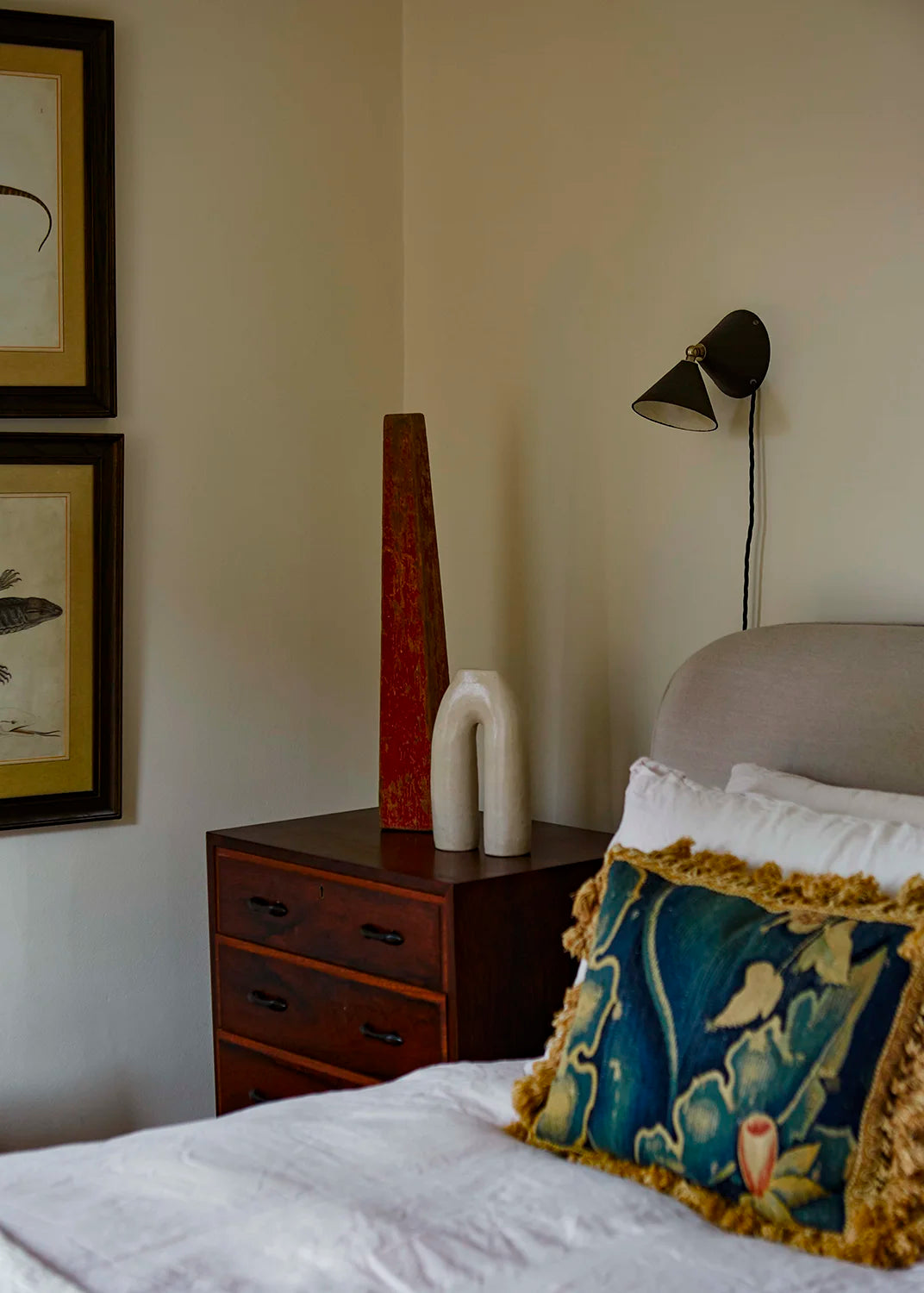 Bedroom with a bed, nightstand, and wall lamp.