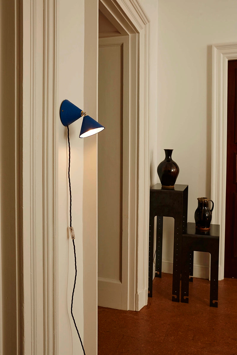 Blue wall lamp switched on in hallway