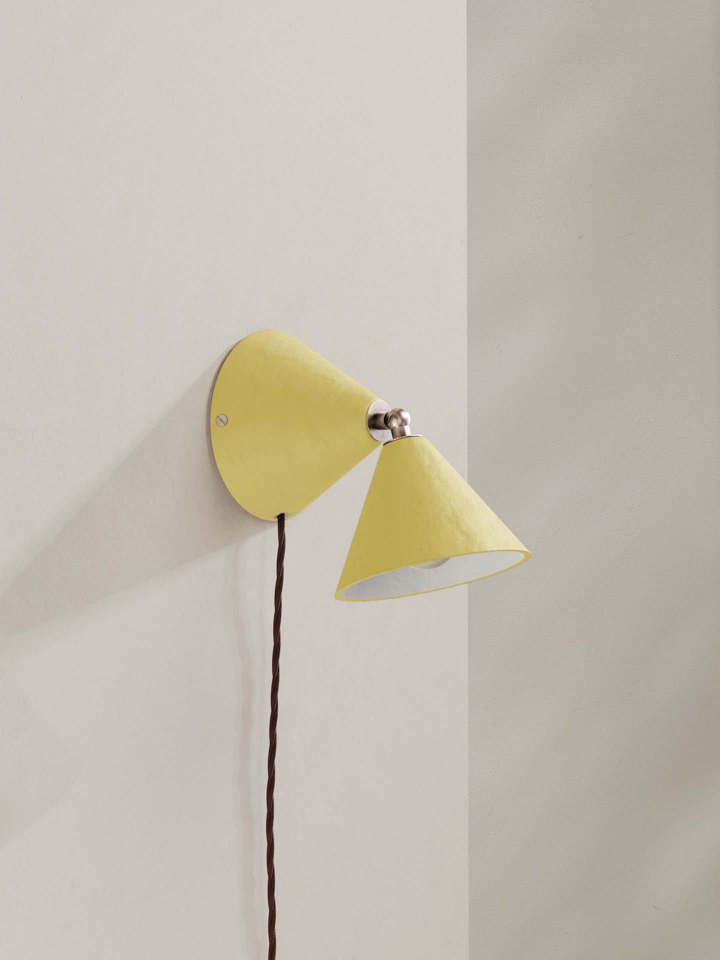 Plug-in Rotor wall light - a conical shaped plug-in wall light, hand-painted in light yellow colour with nickel finishes and beige flex