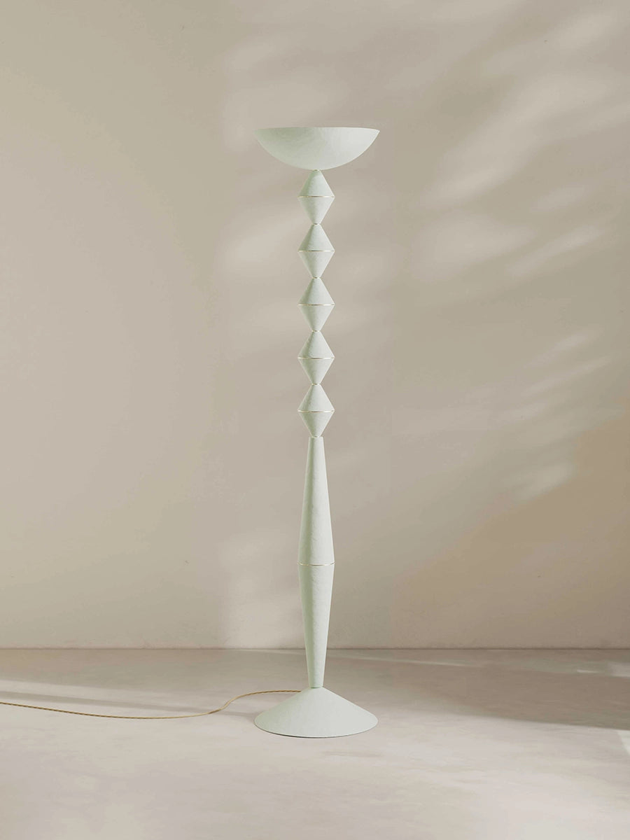 Geometric floor lamp in white against a plain background