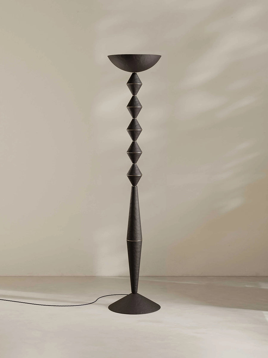Geometric floor lamp in brown-black against a plain background