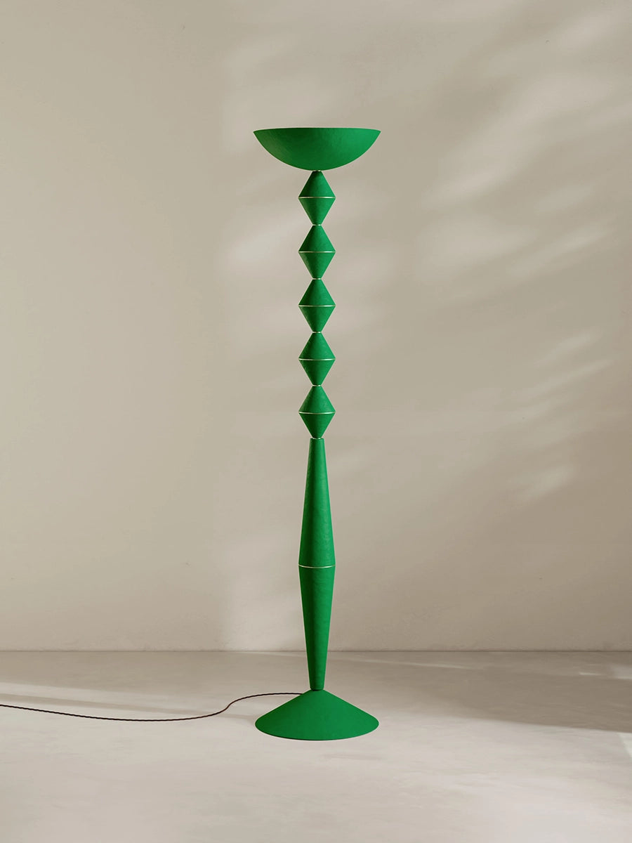 Geometric floor lamp in green against a plain background