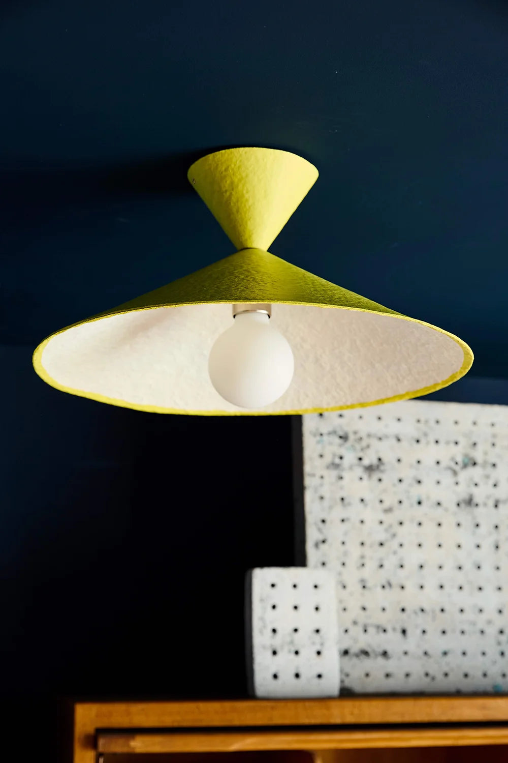 Yellow and white lampshade on a dark background
