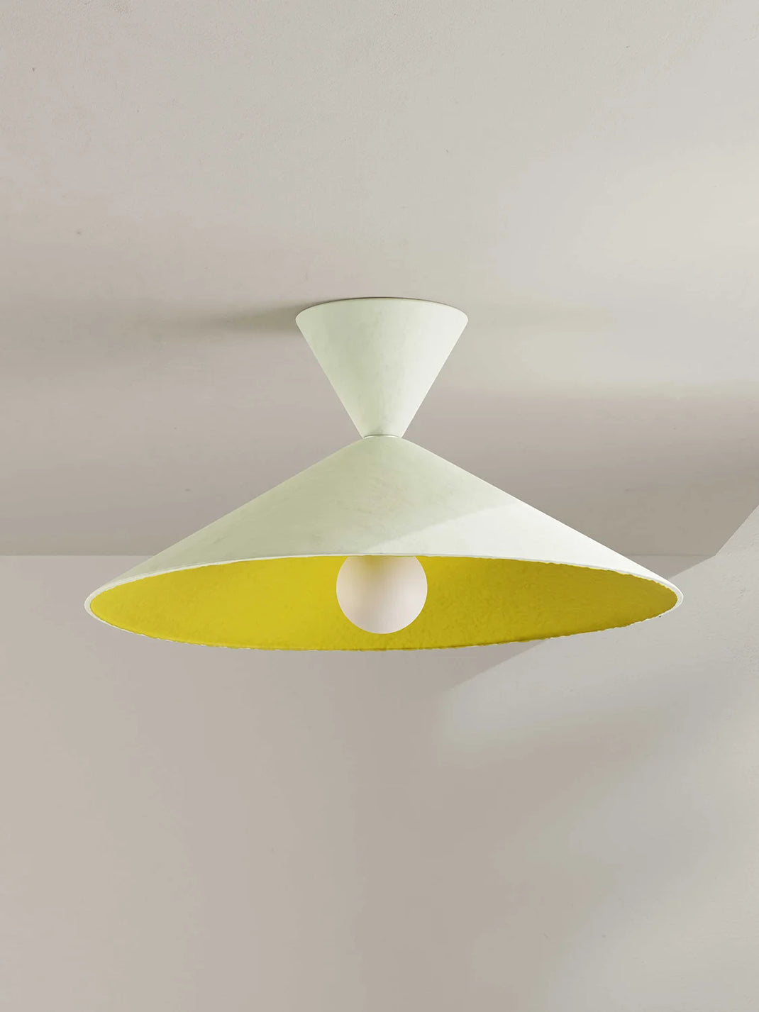 Ceiling light fixture with a yellow interior on a plain background